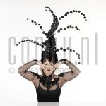 25-02-2004 Trudy Labij at studio in Amsterdam, on behalf of poster -La Bij, Ik voel mij goed-, by order of impresariaat Jacques Senf, February 25, 2004 

[keywords]Posed, Eyecontact, Headgear[/keywords]